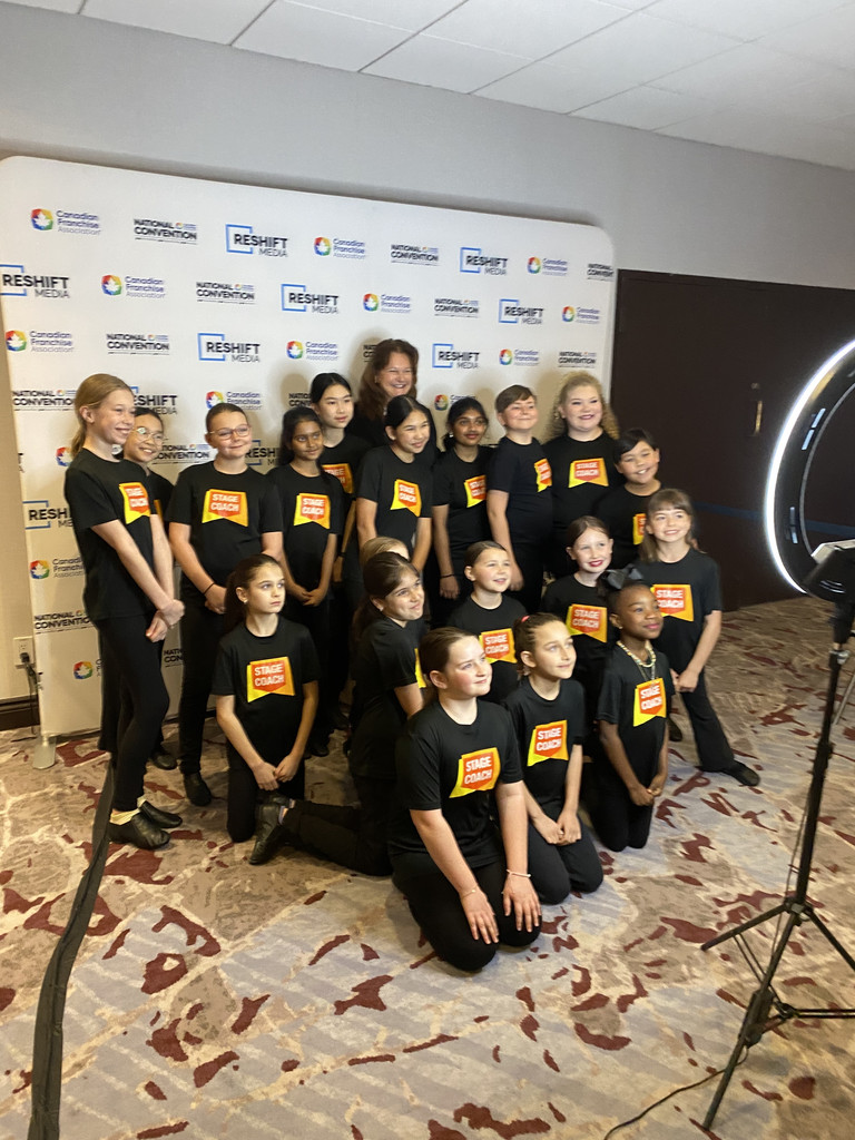 Stagecoach Ottawa West students in Stagecoach T-shirts posing for a group photo at the Canadian Franchise Association National Convention in Ottawa