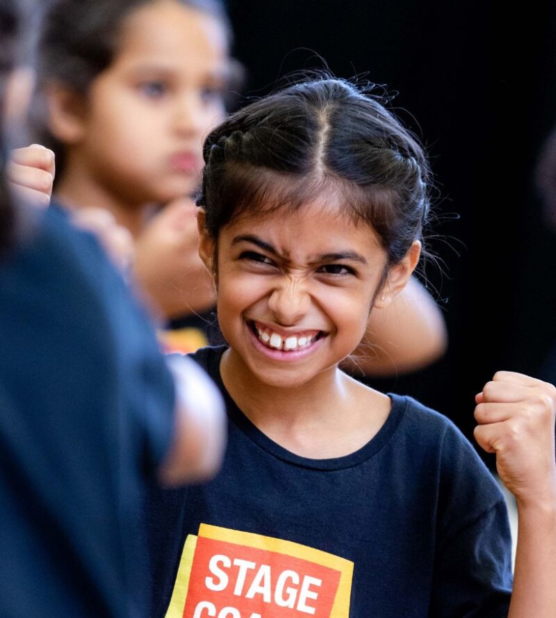 Smiling Stagecoach student in a Stagecoach performing arts class uniform.