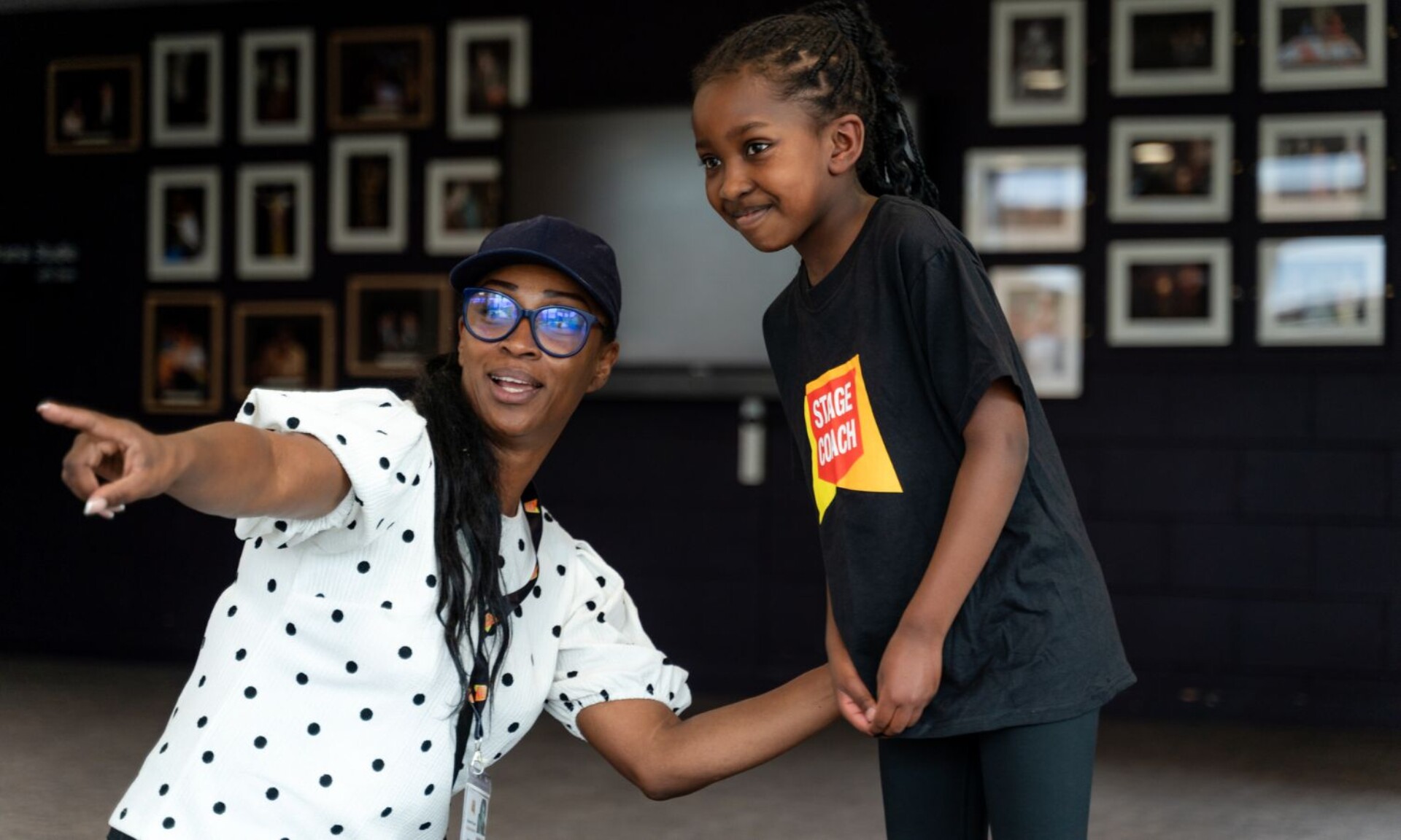 Stagecoach instructor leading young students during a performing arts activity.