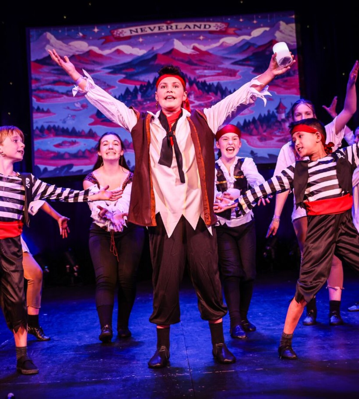 Young Stagecoach student performing on stage during a summer camp production.